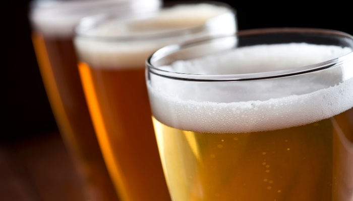 Three beers with foamy heads in a row at Silver Spike Bar & Grill, Dilworth, Minnesota.