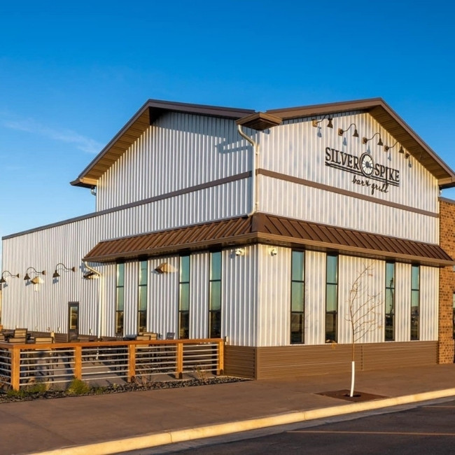 A modern metal building with large windows, Silver Spike Bar & Grill Dilworth Minnesota Restaurant.