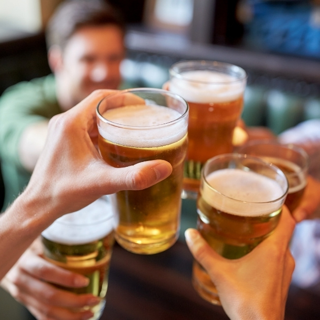 People toasting beers at Silver Spike Bar & Grill, a lively Dilworth Minnesota restaurant.