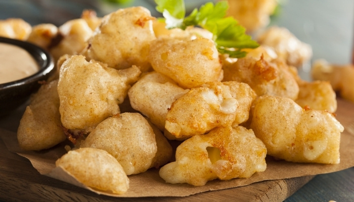Golden, crispy fried cheese curds brighten the Food Menu Dilworth MN, garnished with parsley.