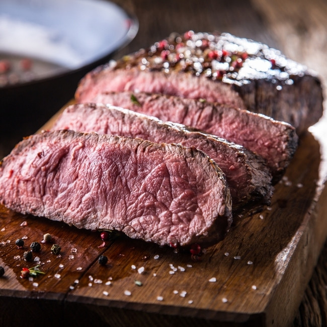 Three thick slices of medium-rare steak at our Restaurant & Bar in Dilworth MN.